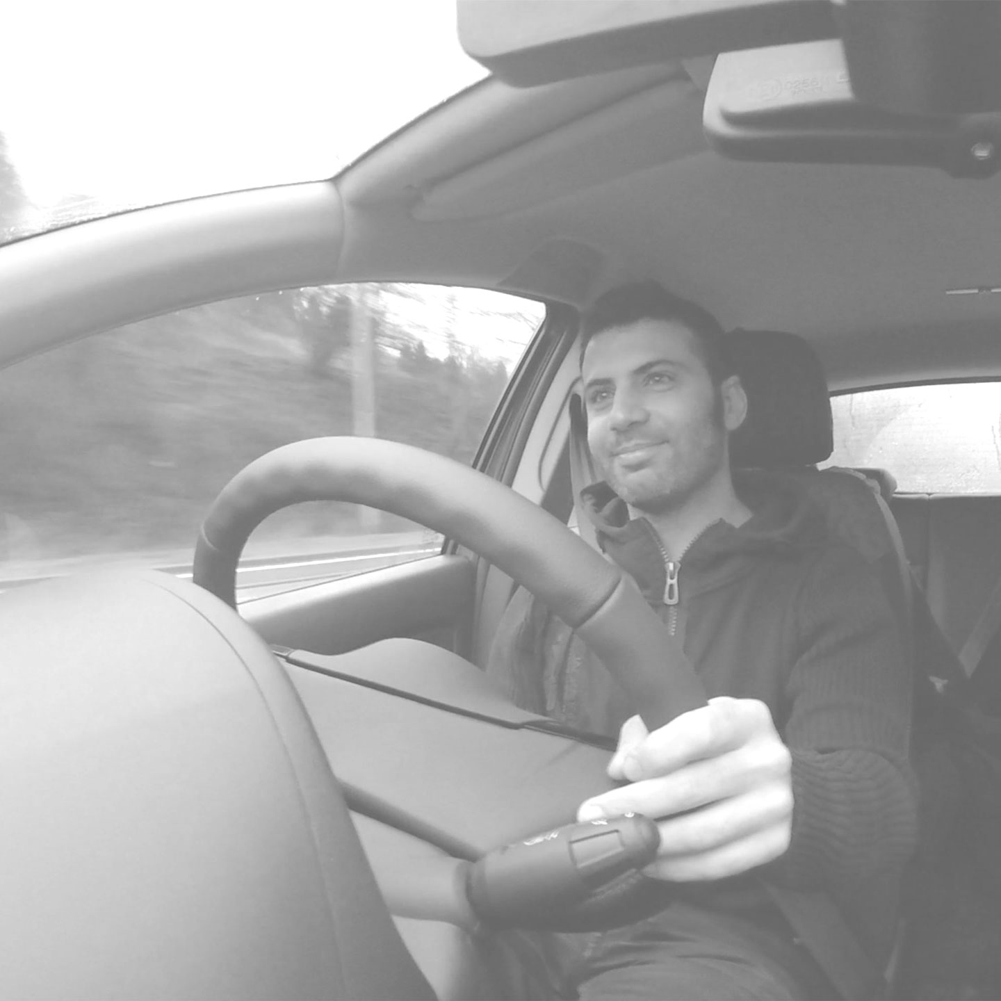 Featured black & white photo of Giulio Bianco driving used for this Hertz portfolio item.